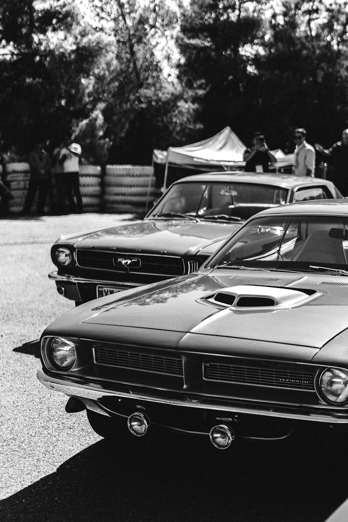 Black and white photo of vintage cars at a classic auto show, capturing a nostalgic moment.